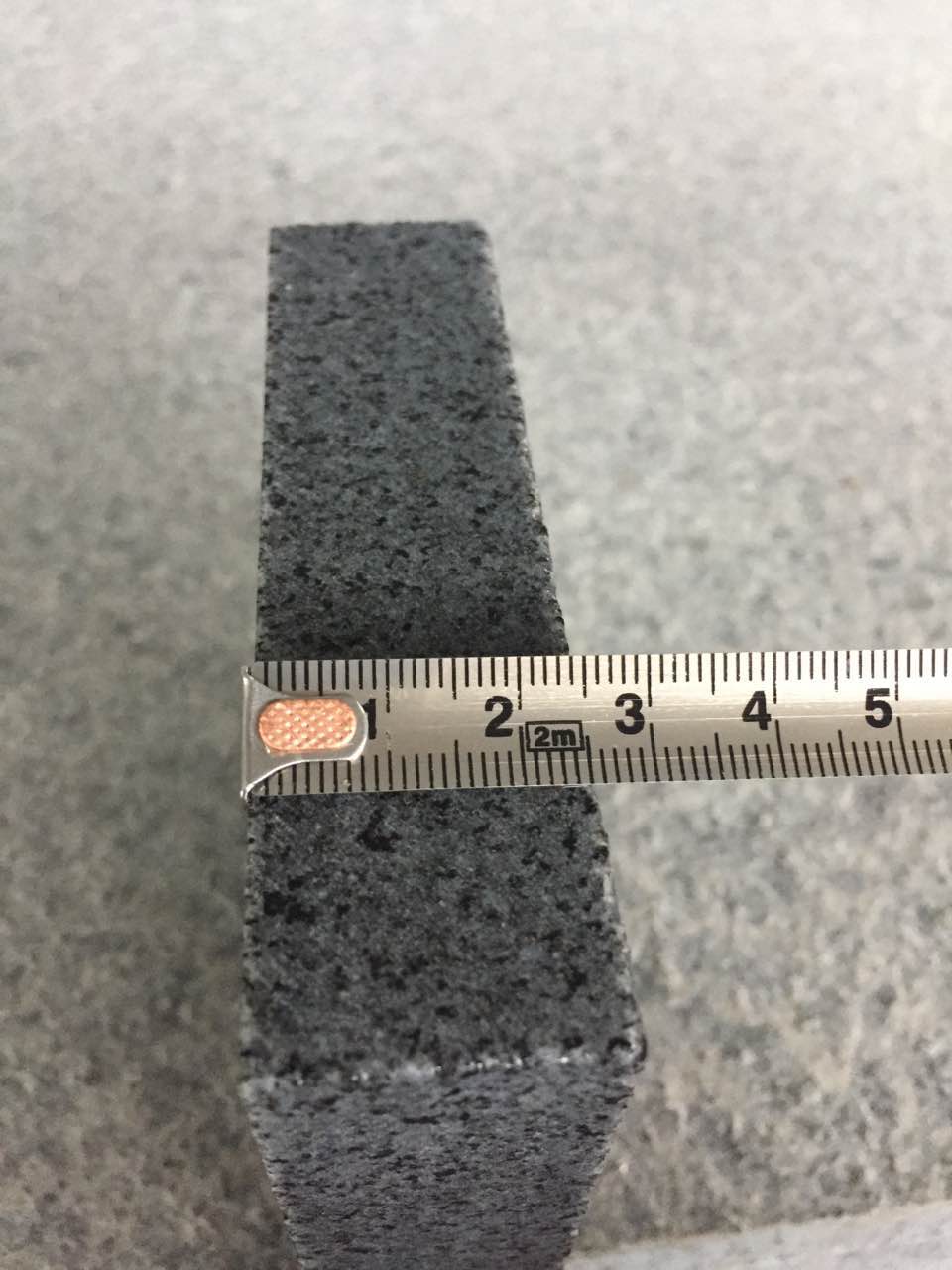 dark grey G654 cobble thickness inspection
